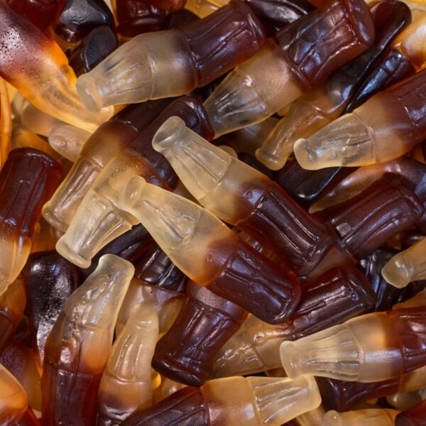 Bonbons gélifiés en forme de bouteilles de cola bicolores, texture lisse et brillante, marque Jake, certifiés Halal.